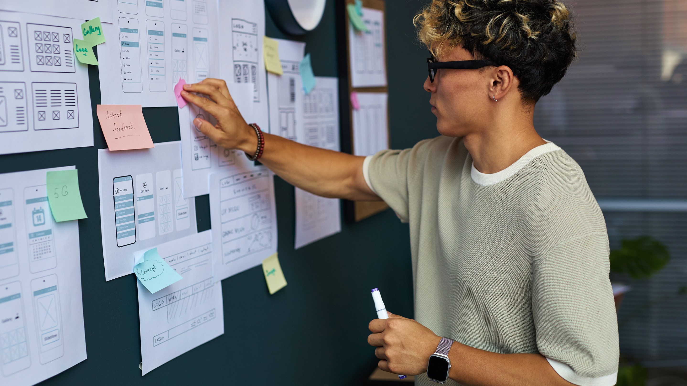 young-adult-caucasian-man-planning-mobile-app-interface-design-wall 1.jpg